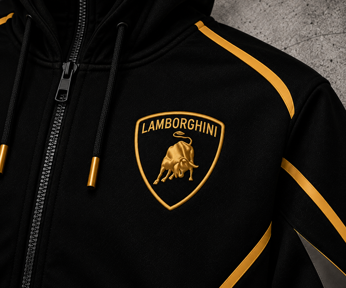 REVLINE Lamborghini hoodie gold shield bull emblem close-up on left chest, black fabric with gold piping