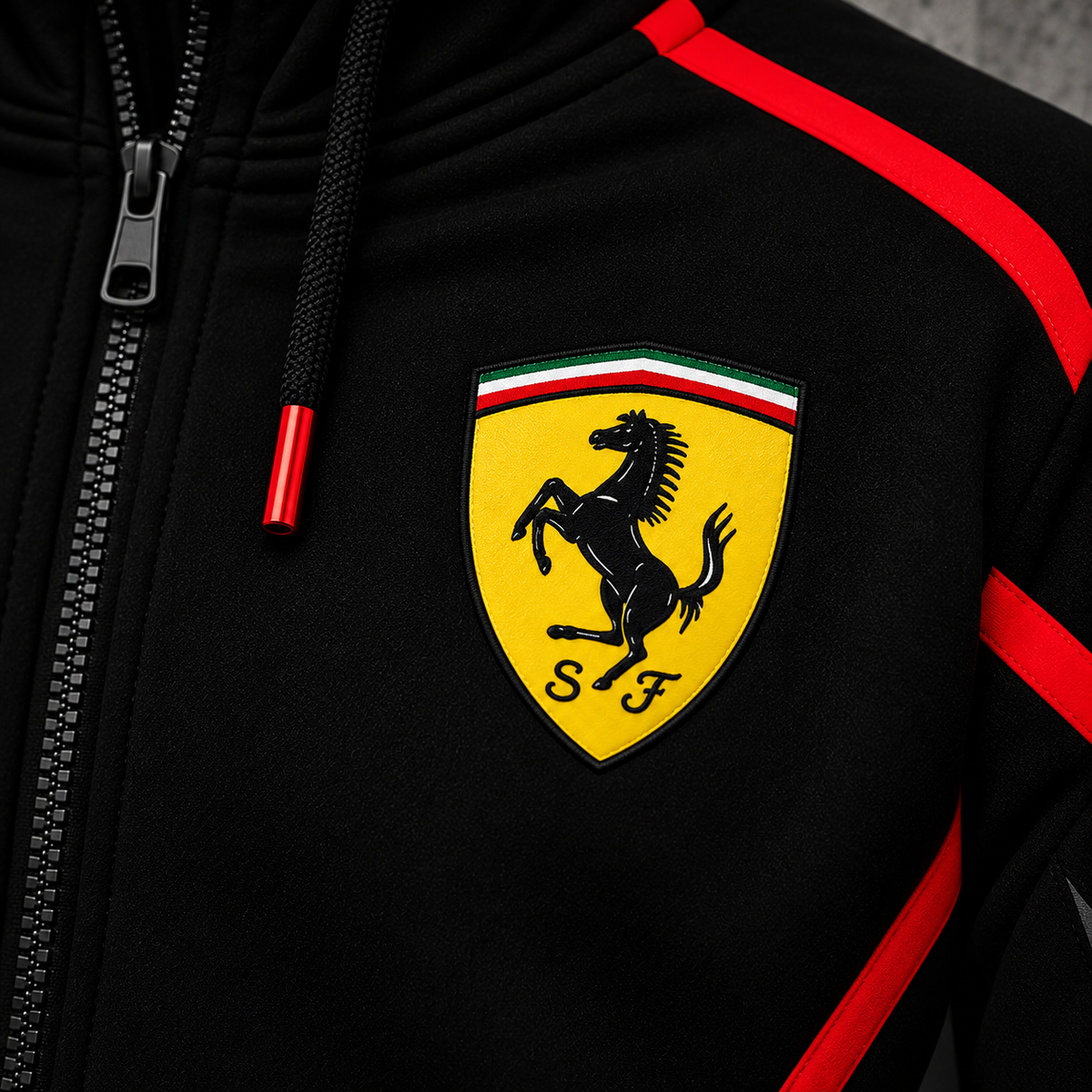 REVLINE Ferrari hoodie yellow prancing horse shield left-chest close-up, black fabric and red piping